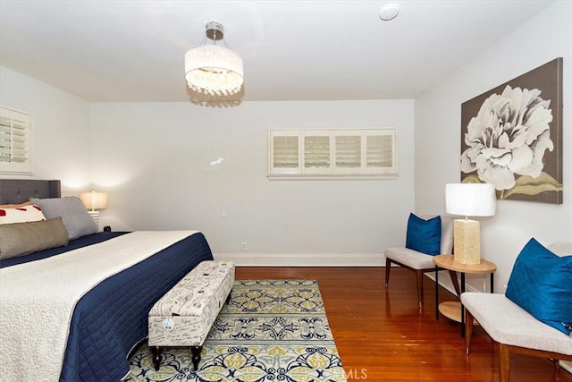 bedroom featuring wood finished floors and baseboards