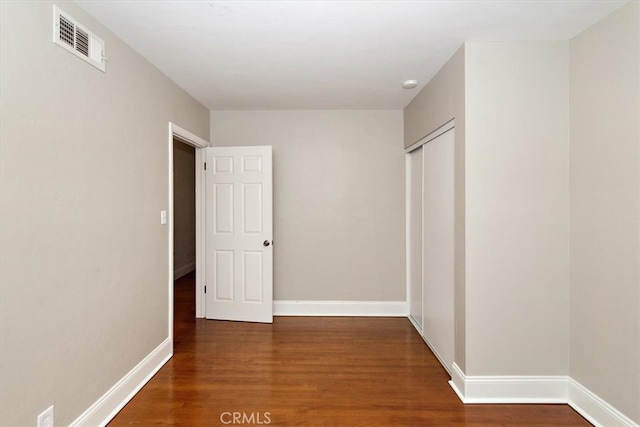 interior space featuring visible vents, baseboards, and wood finished floors