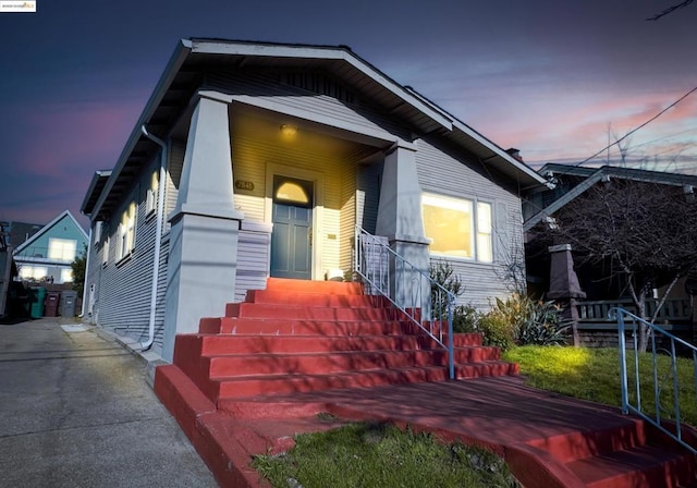 exterior entry at dusk with covered porch