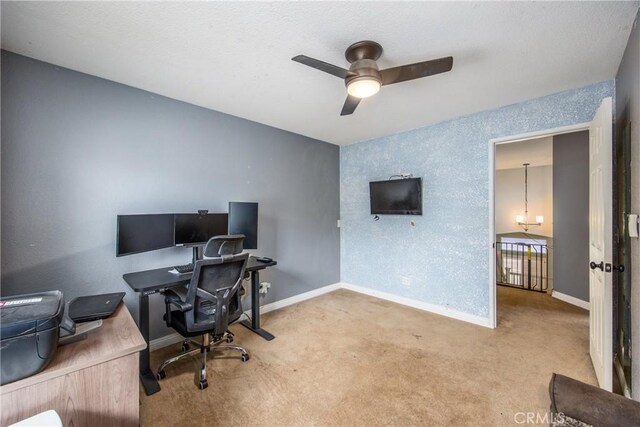 carpeted office featuring ceiling fan