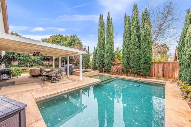 view of pool featuring area for grilling, a patio, ceiling fan, and an in ground hot tub