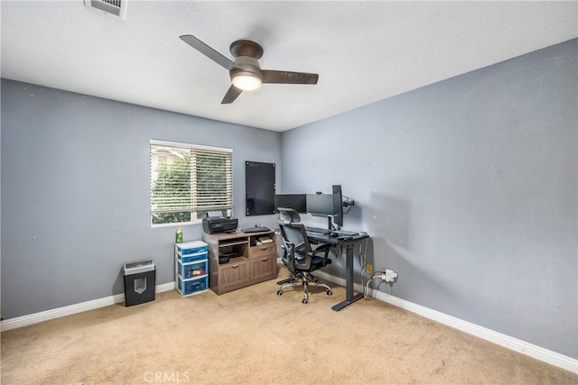 home office with light carpet and ceiling fan