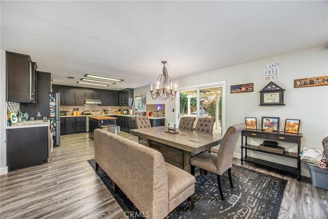 dining room with a notable chandelier and light hardwood / wood-style floors