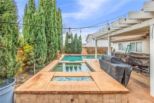 view of swimming pool featuring a pergola, a patio, and an in ground hot tub