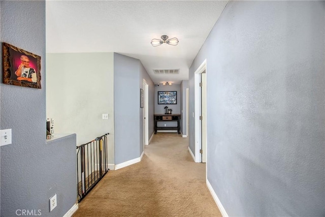 hall with light colored carpet