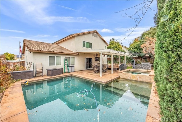 back of property with a patio, a pool with hot tub, and a pergola