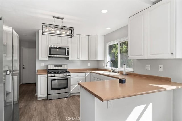 40350 Exa Ely Rd, Hemet, CA 92544 - kitchen featuring appliances with stainless steel finishes, a sink, a peninsula, white cabinets, and recessed lighting