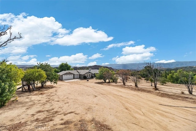 40350 Exa Ely Rd, Hemet, CA 92544 - view of yard with driveway, an attached garage, and a view of rural / pastoral area