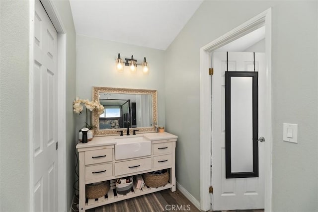 40350 Exa Ely Rd, Hemet, CA 92544 - bathroom with vanity, baseboards, and vaulted ceiling