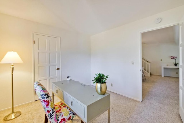 home office featuring light carpet and vaulted ceiling