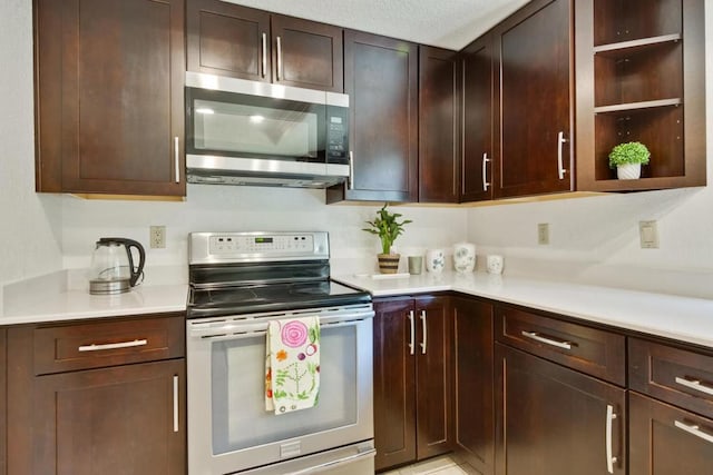 kitchen featuring dark brown cabinetry and appliances with stainless steel finishes