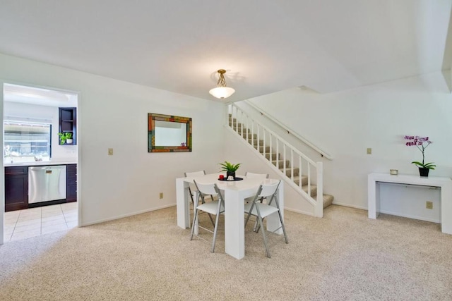 dining area featuring light carpet