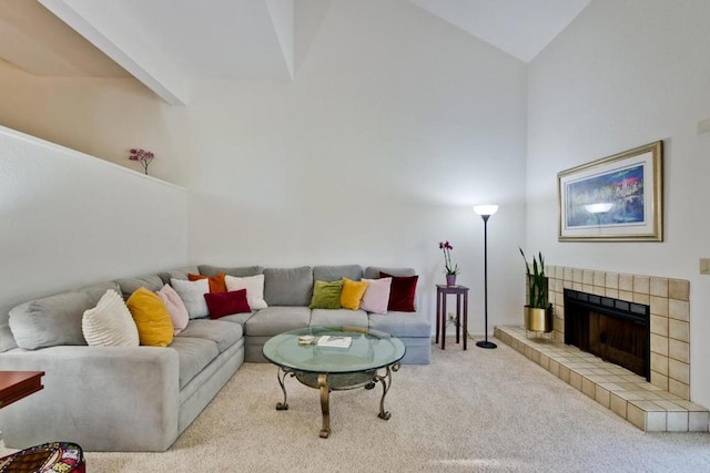 living room featuring high vaulted ceiling, a fireplace, and light colored carpet