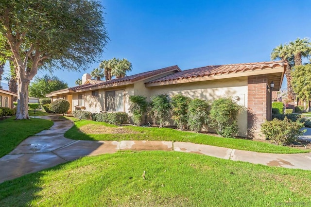 view of side of home with a lawn