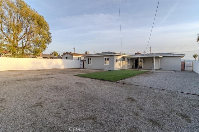 back of house with a yard and a patio area