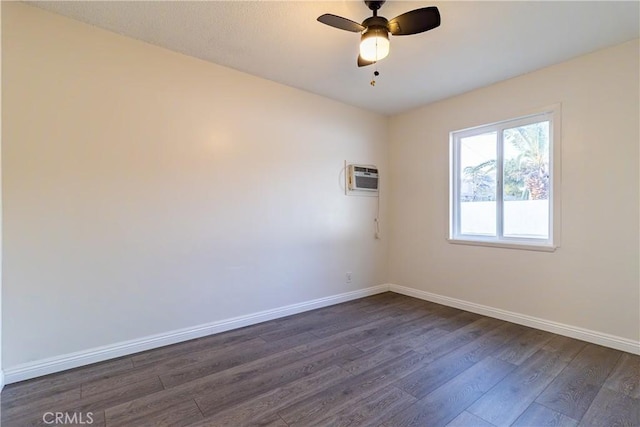 empty room featuring ceiling fan, dark wood-type flooring, and a wall unit AC