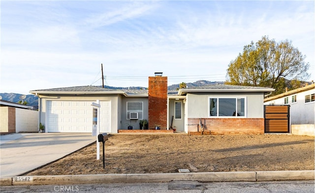 ranch-style home with a garage and cooling unit