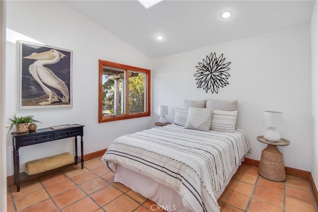 bedroom with vaulted ceiling and light tile patterned flooring