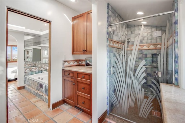 bathroom featuring vanity, tile patterned floors, and separate shower and tub