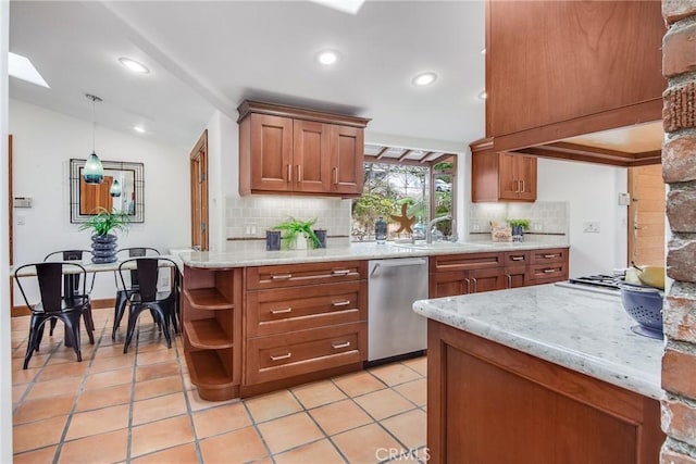 kitchen with tasteful backsplash, hanging light fixtures, stainless steel appliances, and vaulted ceiling with skylight