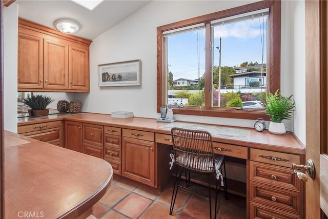 tiled home office featuring built in desk