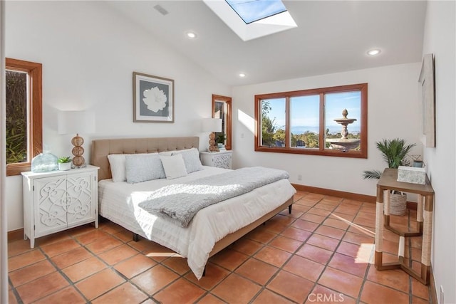 bedroom with tile patterned floors and lofted ceiling with skylight