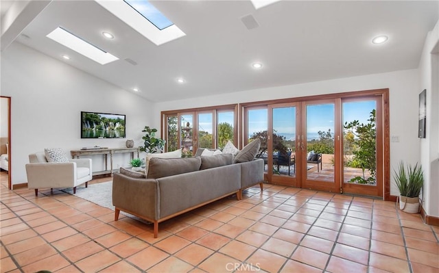 living room with a healthy amount of sunlight, light tile patterned floors, high vaulted ceiling, and a skylight