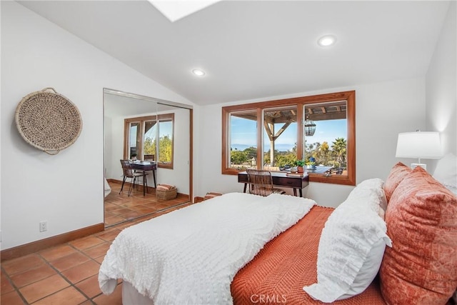 tiled bedroom featuring vaulted ceiling