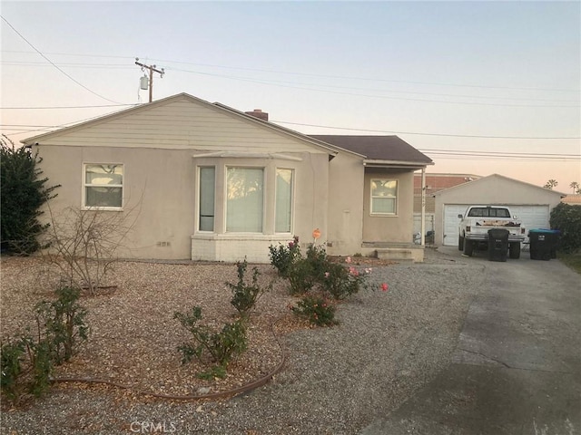 view of front of property with a garage and an outdoor structure