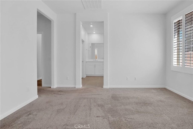 unfurnished room with light colored carpet