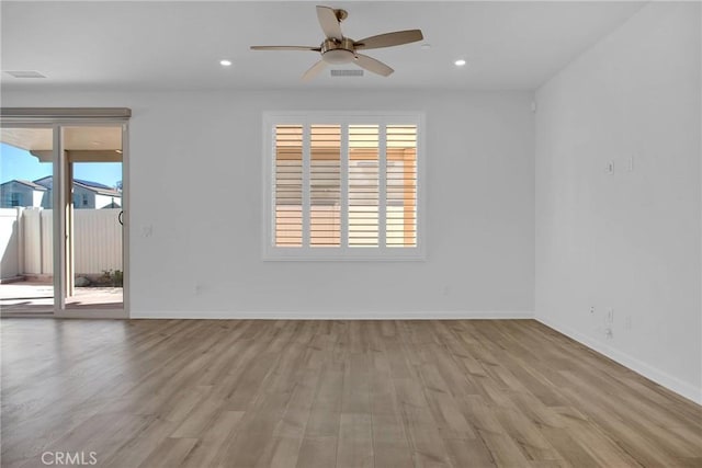 spare room featuring ceiling fan and light hardwood / wood-style flooring