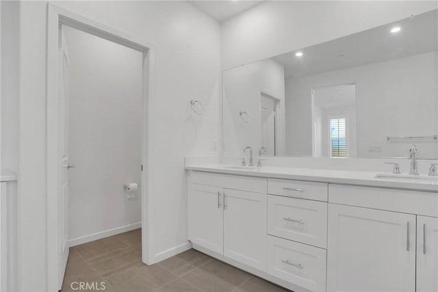 bathroom with tile patterned flooring and vanity