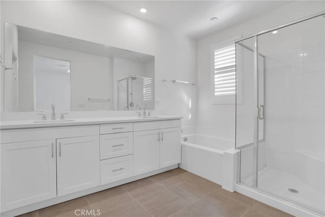 bathroom featuring tile patterned floors, independent shower and bath, and vanity