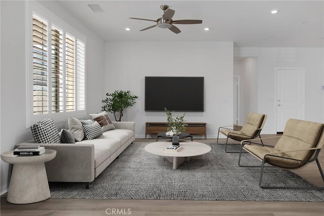 living room featuring hardwood / wood-style flooring and ceiling fan