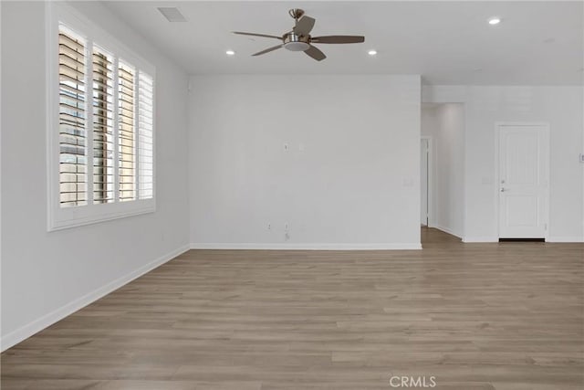 spare room with ceiling fan and light hardwood / wood-style floors