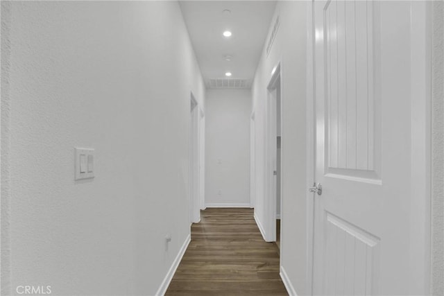 hallway with dark hardwood / wood-style floors