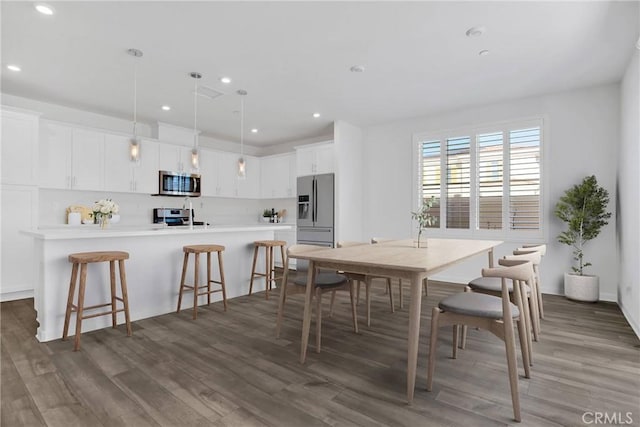 dining area featuring dark hardwood / wood-style flooring