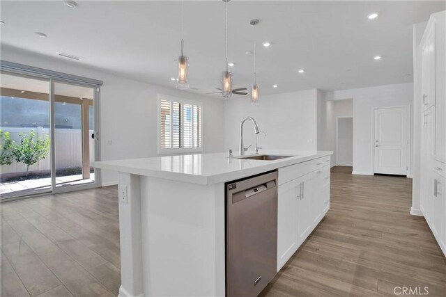 kitchen featuring white cabinets, an island with sink, pendant lighting, and dishwasher