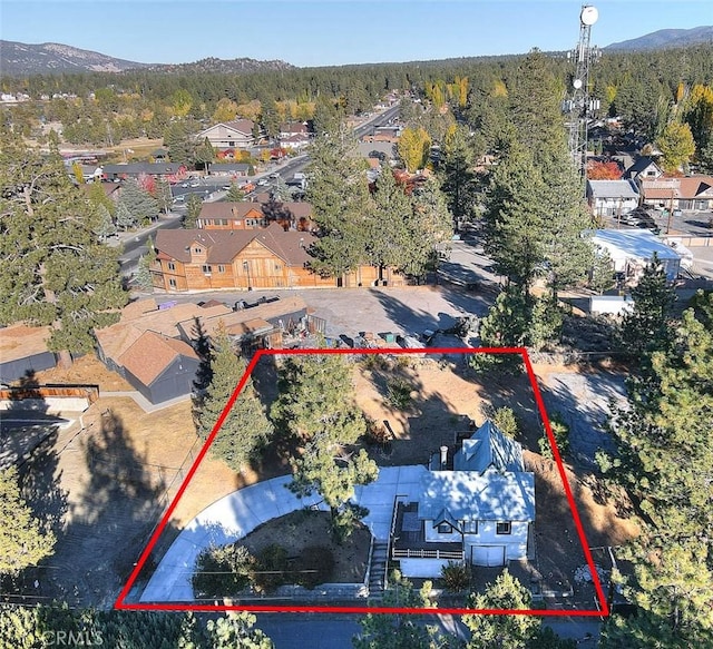 birds eye view of property with a mountain view