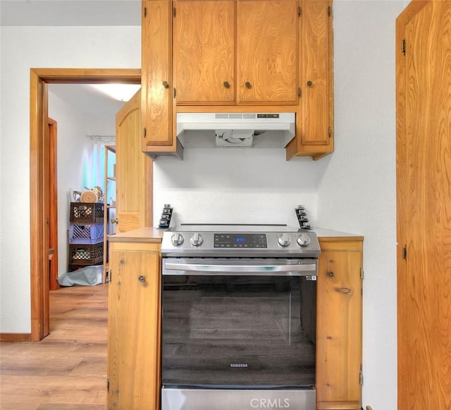 kitchen featuring light hardwood / wood-style flooring and stainless steel electric range