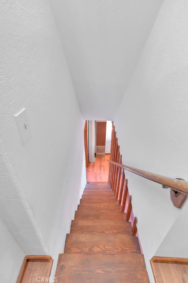 stairs featuring hardwood / wood-style flooring