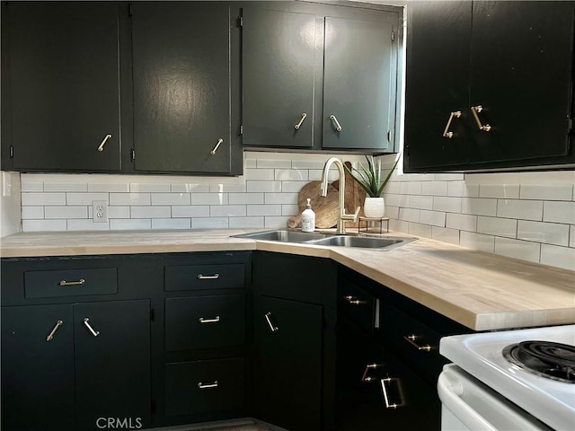 kitchen featuring butcher block counters, white range with electric cooktop, a sink, and tasteful backsplash