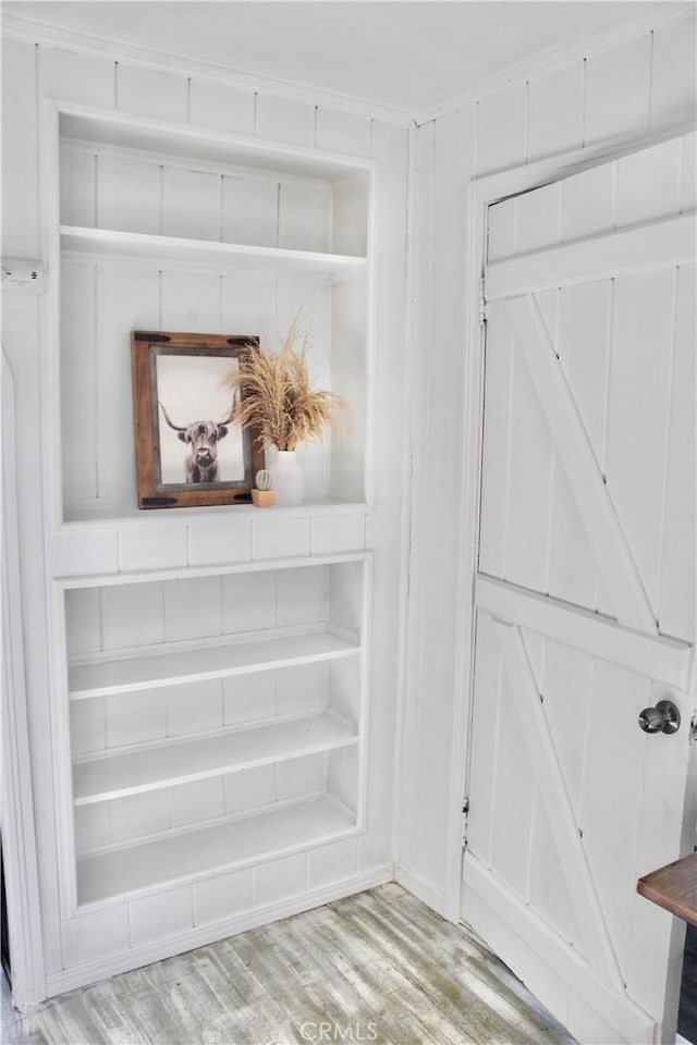 interior details featuring hardwood / wood-style floors and ornamental molding