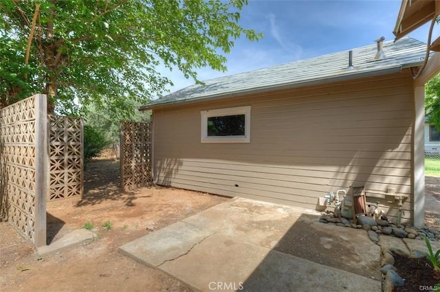 view of side of property with a patio area