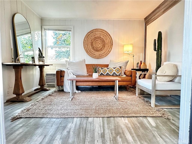 sitting room featuring hardwood / wood-style flooring and ornamental molding