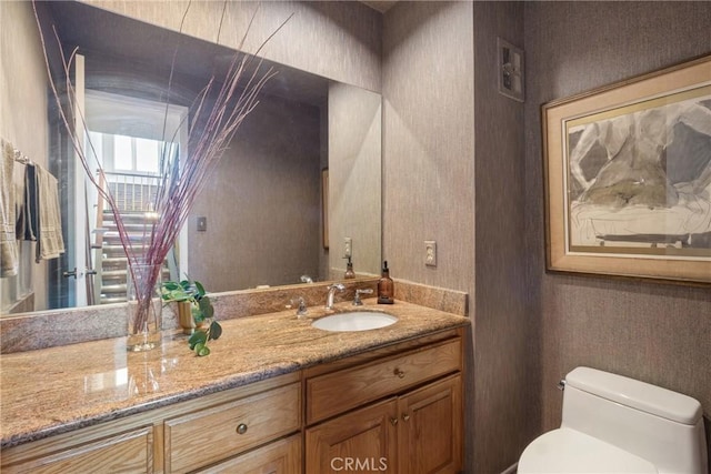 bathroom featuring a skylight, vanity, and toilet