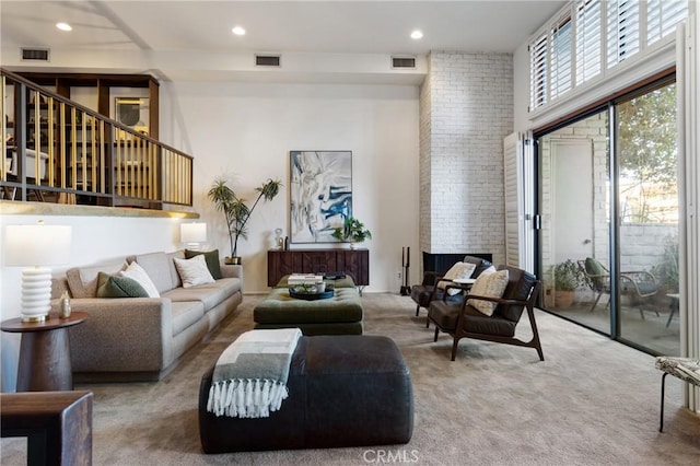 carpeted living room featuring a towering ceiling