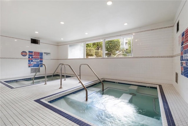 view of swimming pool with an indoor in ground hot tub