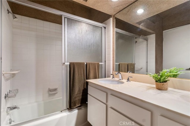 bathroom featuring enclosed tub / shower combo and vanity