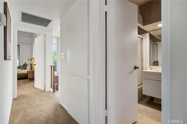 hallway with light colored carpet